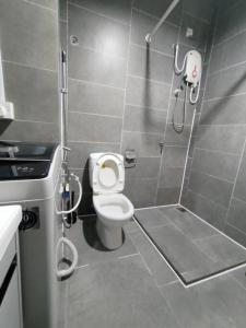 a small bathroom with a toilet and a shower at Breeze Cottage@Empire Damansara in Petaling Jaya