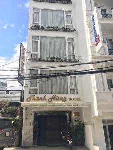 un edificio blanco con un cartel que lee a los comensales comer caliente en Thanh Hùng Dalat Hotel en Da Lat