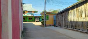 an empty alley with a group of shops and buildings at RuengsriSiri Guesthouse in Sukhothai