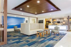 an office lobby with a reception desk and chairs at Holiday Inn Express & Suites Newport News by IHG in Newport News