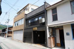 an empty street with a building with a garage at Sakara Miyazu in Miyazu
