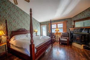 um quarto com uma cama e uma lareira em Albergo Allegria Hotel & Breakfast Restaurant em Windham