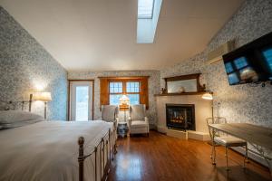 a bedroom with a bed and a fireplace at Albergo Allegria Hotel in Windham