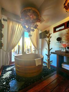 a bathroom with a large tub in the middle of the room at Grand Kokkod Khao Kho Resort in Khao Kho