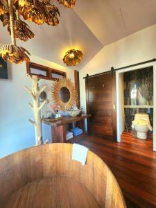 a room with a wooden table and a mirror at Grand Kokkod Khao Kho Resort in Khao Kho