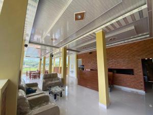 - un salon avec des canapés et un mur en briques dans l'établissement Tama View, à Tuk Tuk