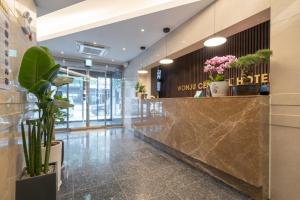 a lobby with a marble counter and plants at Wonju Central Hotel in Wonju