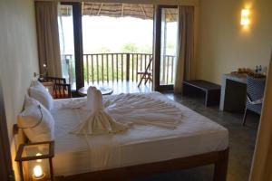 Voodi või voodid majutusasutuse Giman Free Beach Resort toas
