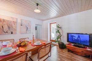 a living room with a table and a television at Casa Traversi - Happy Rentals in Cevio