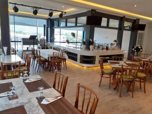 a restaurant with tables and chairs and a bar at Karnyapha Hotspring hotel in Ban Lum Than