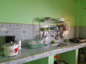 a kitchen counter with a sink and some dishes at Mj Transient Homes in Baguio