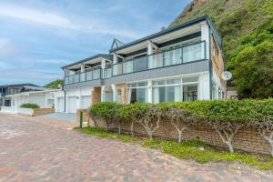 a house on a hill with a brick driveway at Vic Bay Beach House in Victoria Bay