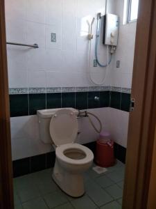 a bathroom with a toilet and a shower in it at Sharaa seaview Apartment in Port Dickson