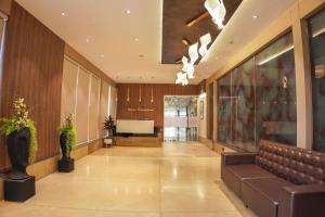 a lobby with a couch in a building at Ramee International Surat in Surat