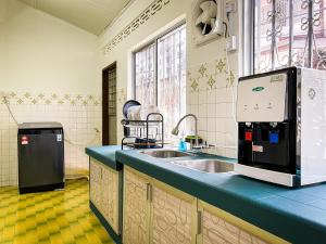 a kitchen with a sink and a microwave at Lake View 53 Heritage 4BR by LOUIS in Taiping