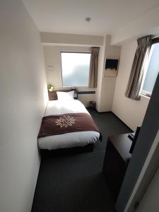 a hotel room with a bed and a window at Floral Hotel &middot; SakaisuJi-Honmachi Osaka in Osaka