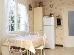 a kitchen with a table and a refrigerator at Maison Saint-Trojan-les-Bains, 3 pièces, 5 personnes - FR-1-246A-353 in Saint-Trojan-les-Bains