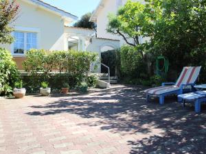 a patio with two benches and a house at Maison Saint-Trojan-les-Bains, 3 pièces, 5 personnes - FR-1-246A-353 in Saint-Trojan-les-Bains