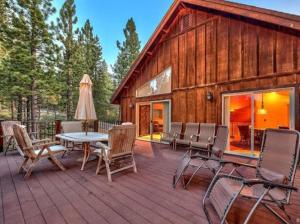 a deck with a table and chairs and a barn at Tahoe Alpine Lodge in South Lake Tahoe