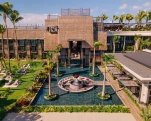 an aerial view of a building with a fountain and palm trees at LUX* Grand Baie Resort & Residences in Grand Baie