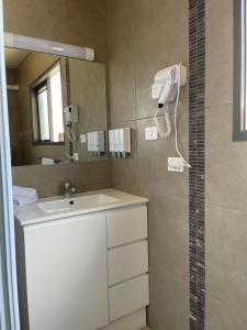 a bathroom with a sink and a mirror at SHEPPARTON MOTOR INN Tudor House Motel in Shepparton