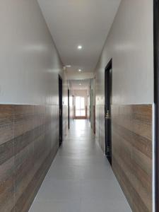 a hallway of a building with wooden walls and doors at Alohaa Homestel in Coimbatore