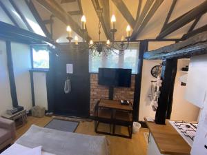 a room with a bed and a tv in it at Windsor/Ascot/Bracknell beautiful barn in Bracknell