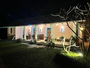 a house with a patio at night with lights at Ella Nine Peaks in Ella