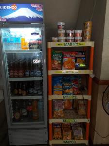 a refrigerator filled with lots of food and drinks at MACTAN AIRPORT HILLTOP HOTEL in Mactan
