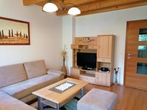 sala de estar con sofá y mesa en Haus zur Mühle, en Ried im Oberinntal