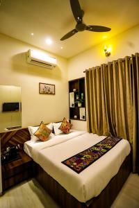 a bedroom with two beds and a ceiling fan at Lavanya Villa with private pool Udaipur in Udaipur +28 photos