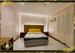 a bedroom with a bed with a yellow pillow at White Knights Real in Dumaguete