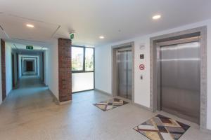 an empty hallway with two elevators in a building at Complex Gallery Vitosha **** in Sofia