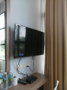 a flat screen tv hanging on a wall at CHARISMA HOTEL in Kuantan