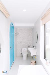 a bathroom with a white toilet and a blue door at Sunmay Villa Tam Dao - Venuestay in Vĩnh Phúc +35 photos