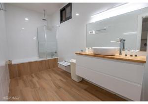 a white bathroom with a sink and a shower at Dream House Tiberias in Tiberias +11 photos