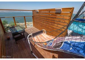 a hammock sitting on the deck of a boat at Dream House Tiberias in Tiberias