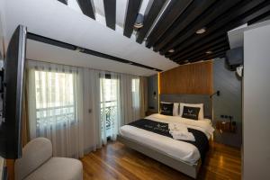 Un dormitorio con una cama grande y un balcón. en Roe Suite Hotel - TAKSIM, en Estambul 139 fotos más