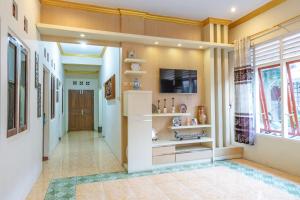 a hallway of a home with a television and a tv stand at Metro Malioboro Living in Yogyakarta