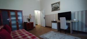 a living room with a bed and a television at Hotel Vojvodina in Novi Sad