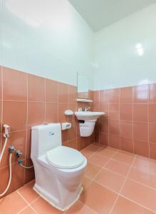 a bathroom with a toilet and a sink at Capital O 75412 V Resort in Nakhon Nayok