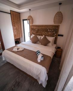 Postel nebo postele na pokoji v ubytování kunaa beach Inn