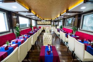 a dining room with red and blue tables and chairs at The Fern Residency Katra in Katra