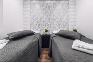 Posteľ alebo postele v izbe v ubytovaní White Apartment