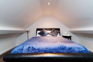 a bedroom with a large bed in a attic at West Park House in Bramhope