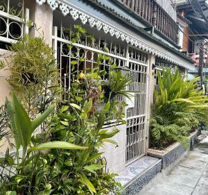 a building with a white gate with plants on it at Hidden Lumpu in Bangkok