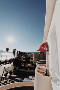 a balcony with a view of the beach and the ocean at Le Rose Thé in La Ciotat