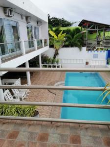 a view from the balcony of a house with a swimming pool at Germaroze in Oslob