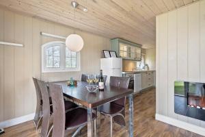 a kitchen with a dining room table and chairs at First Camp Hasmark Camping Resort & Cottages in Otterup