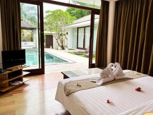 a hotel room with a bed with towels on it at The Wangsa Hotel and Villas Benoa in Nusa Dua